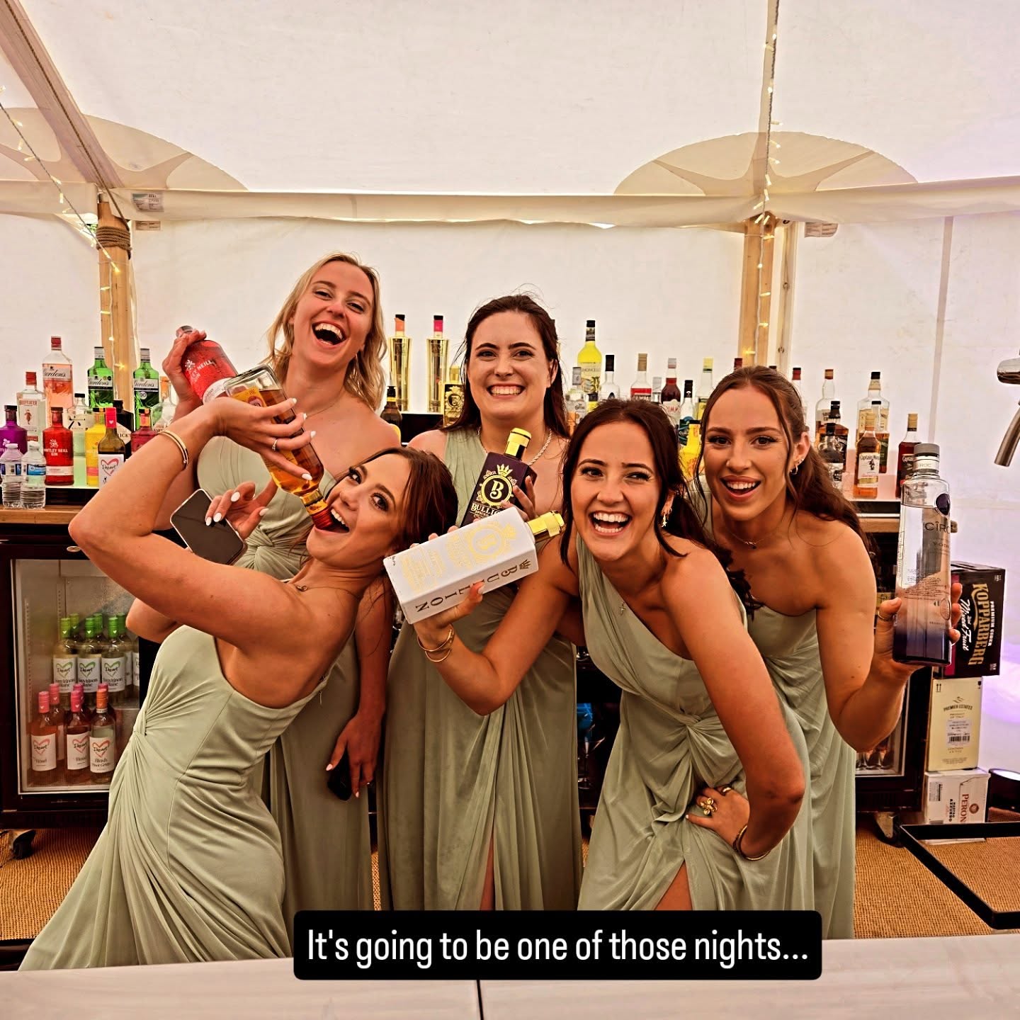 Bridesmaids enjoying cocktails at a mobile bar during a London wedding reception