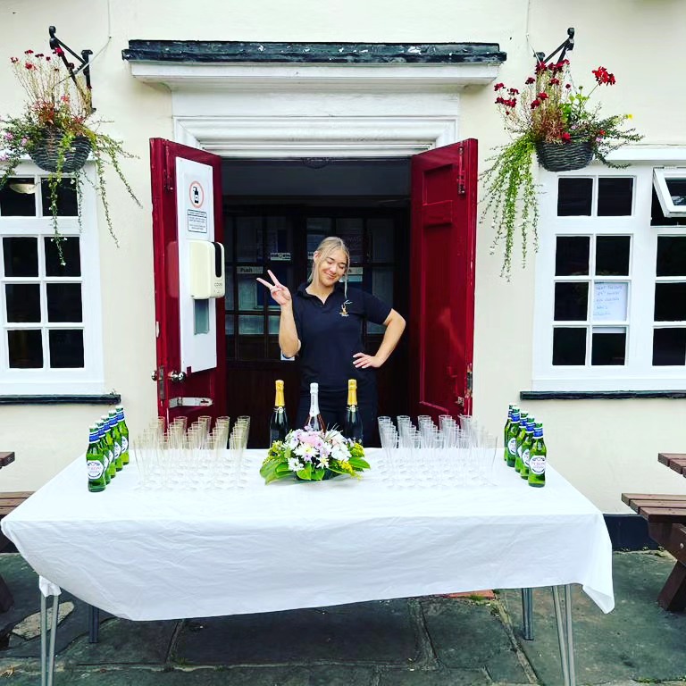 Bartender serving champagne at a private event in London