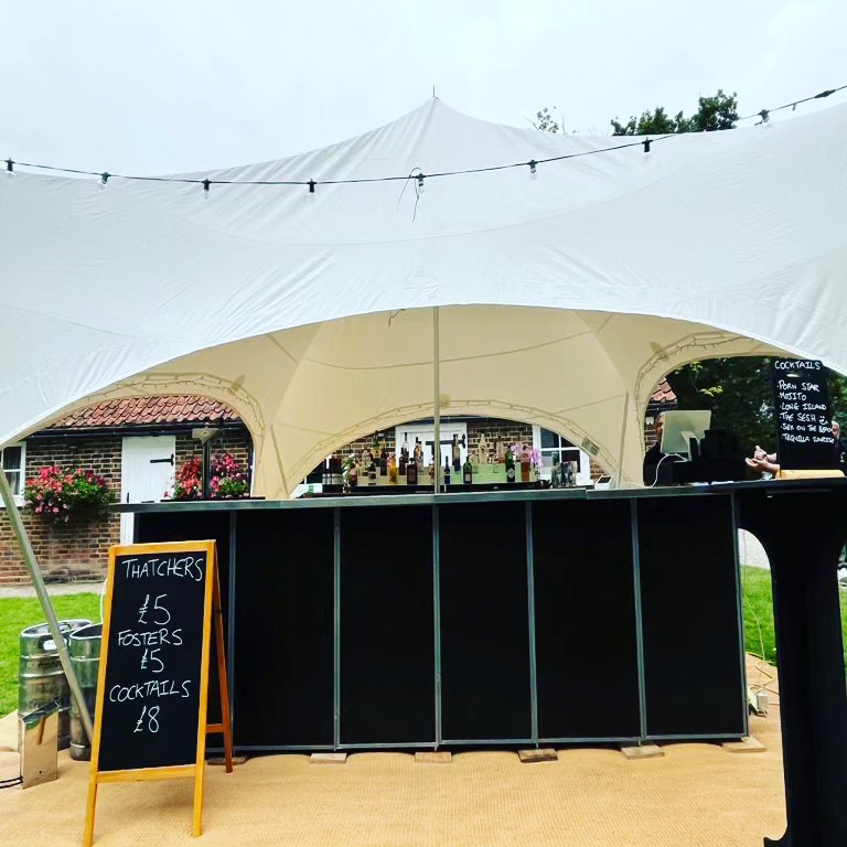 Mobile bar tent with chalkboard menu at a Berkshire event