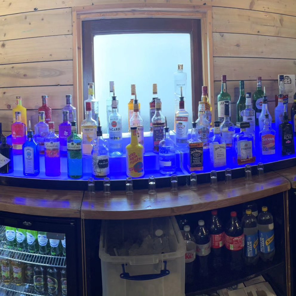 Premium spirits display at a mobile bar hire setup with LED lighting